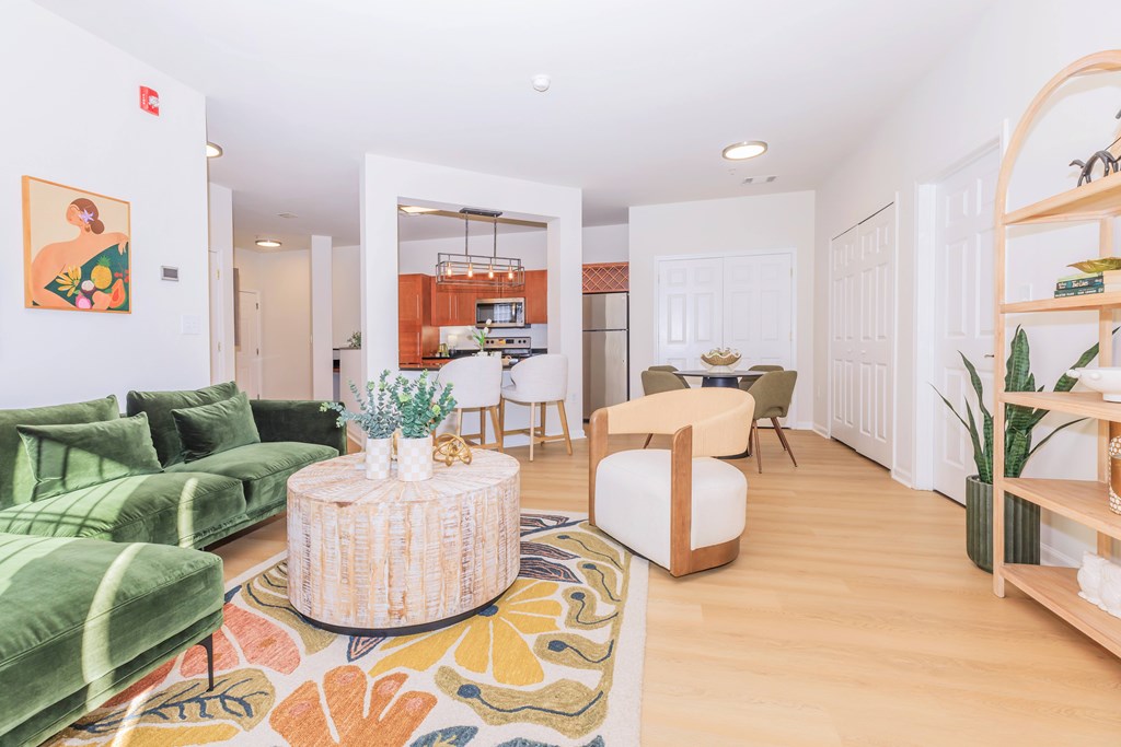 A living room with a green couch and a wooden coffee table.
