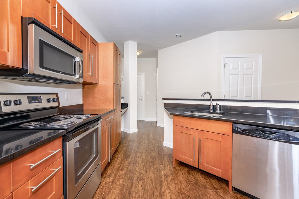 A kitchen with wooden cabinets and stainless steel appliances.