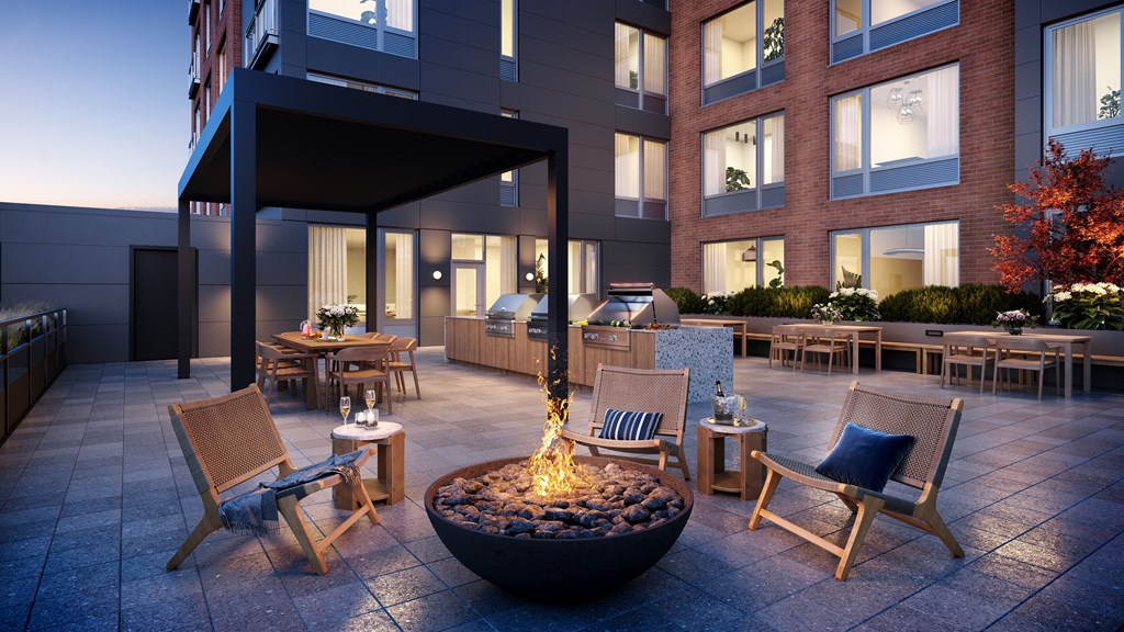 Crackling with flickering flames, offers a cozy gathering spot for friends and neighbors to enjoy the comforting warmth and relaxed atmosphere our fire pit provides.
