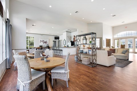 A spacious living room with a dining table and chairs.