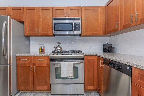 A kitchen with wooden cabinets and stainless steel appliances.