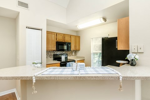 A kitchen with a table set for a meal.