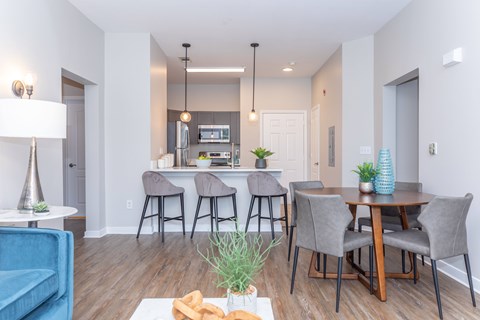A modern dining room with a table set for four.