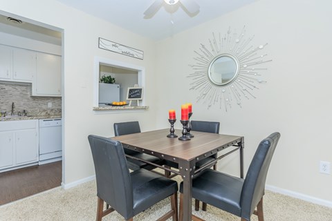 A dining room with a table and chairs.