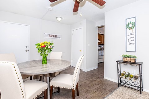 A dining room with a round table and chairs.