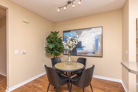 A dining room with a table and chairs.