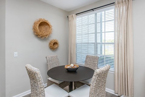 A dining room with a round table and chairs.