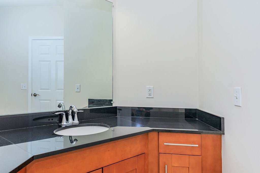 A bathroom with a sink and a mirror.