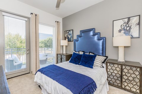 A bedroom with a large bed and a blue headboard.
