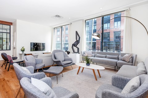A living room with grey chairs and a white couch.