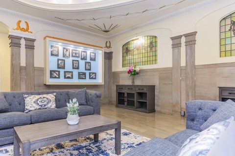 A living room with a grey couch and a wooden coffee table.