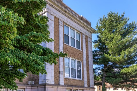 A building with a tree in front of it.