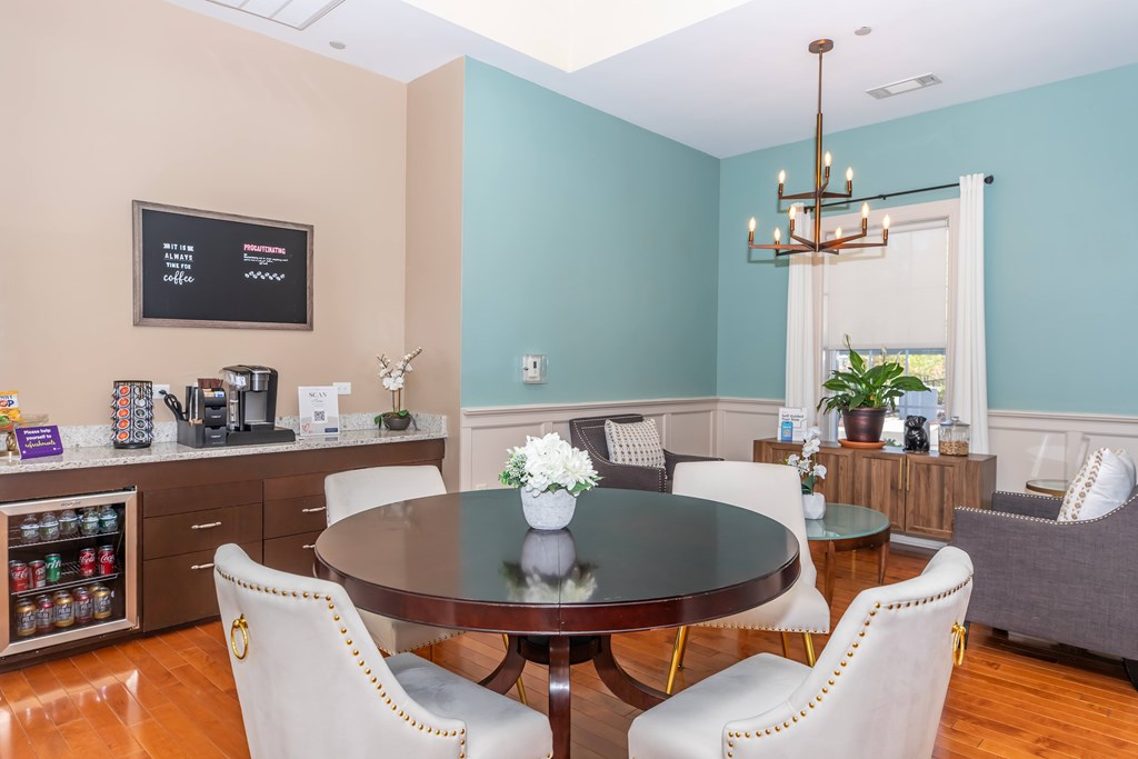 A dining room with a table set for four.