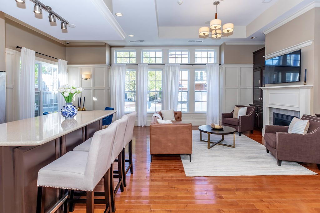 A well-lit, spacious living room with a dining area and a fireplace.
