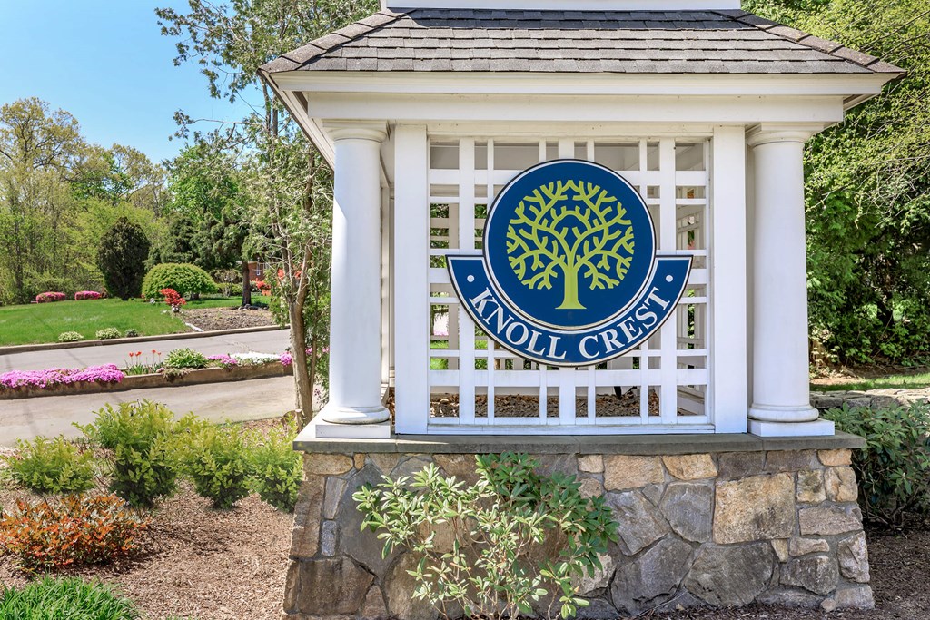 A white pillar with a tree logo and the words