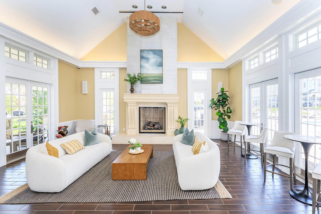 A living room with a fireplace and a painting on the wall.