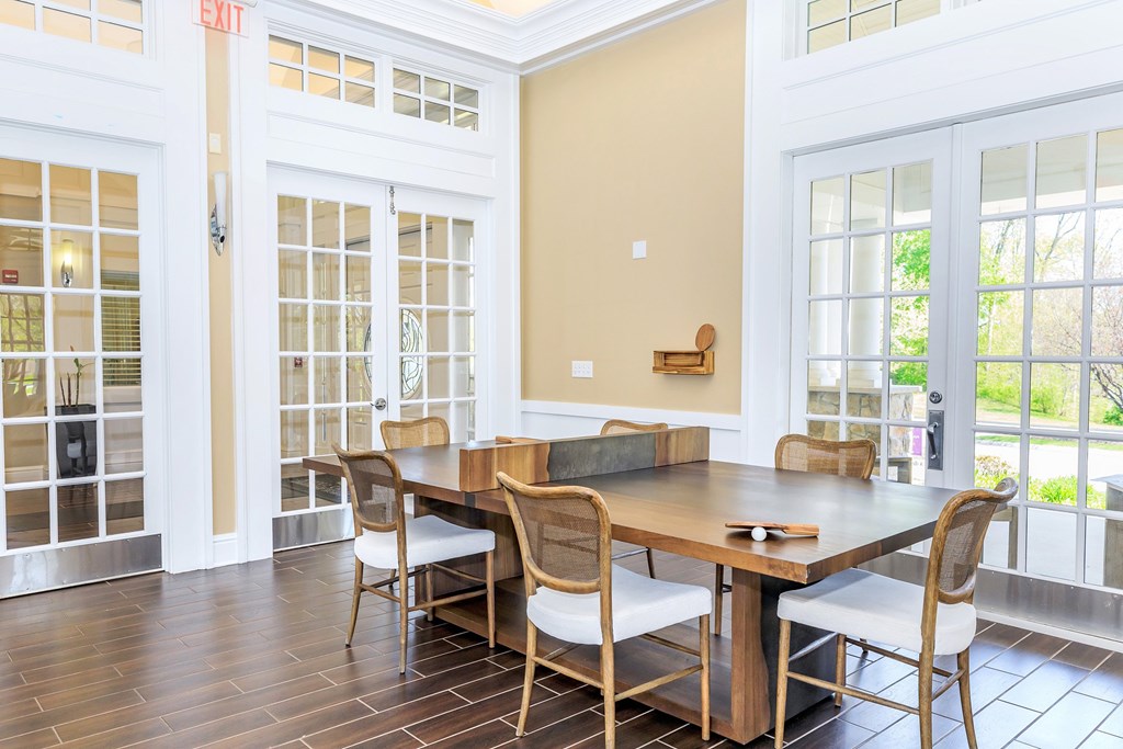A dining room with a wooden table and chairs.