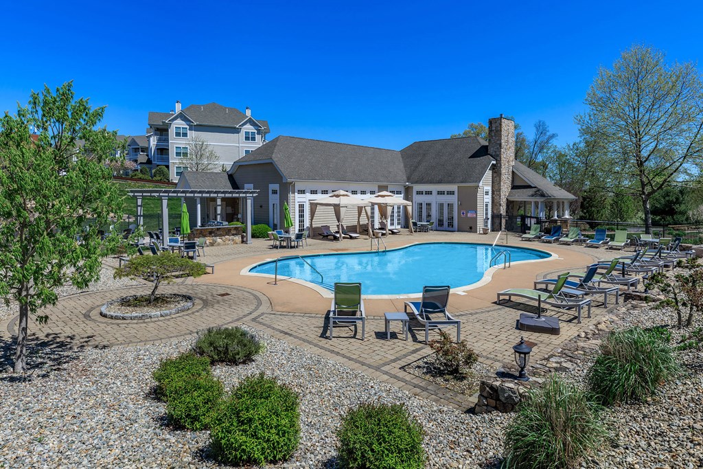 A large house with a pool in the backyard.
