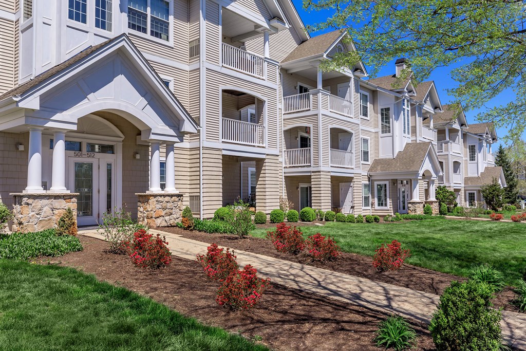A row of houses with a landscaped front yard.