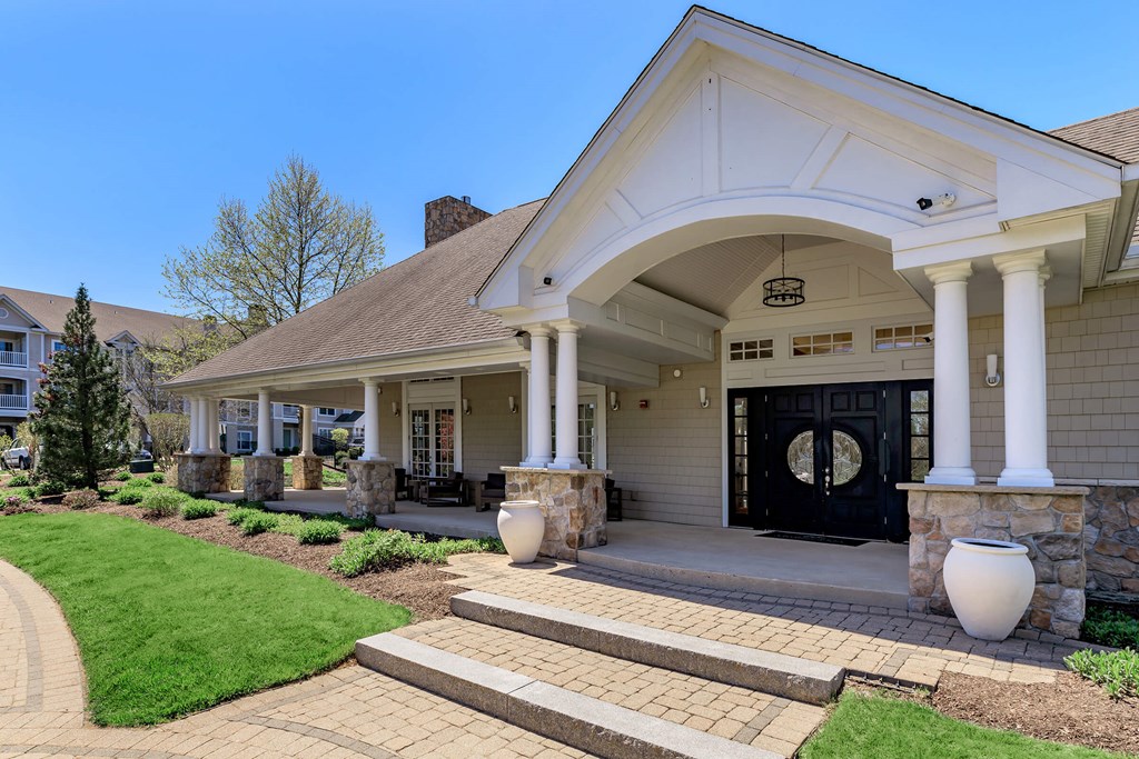 A house with a black front door and white columns.