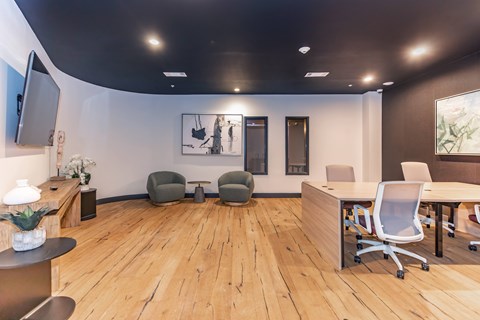A modern office space with wooden floors and furniture.