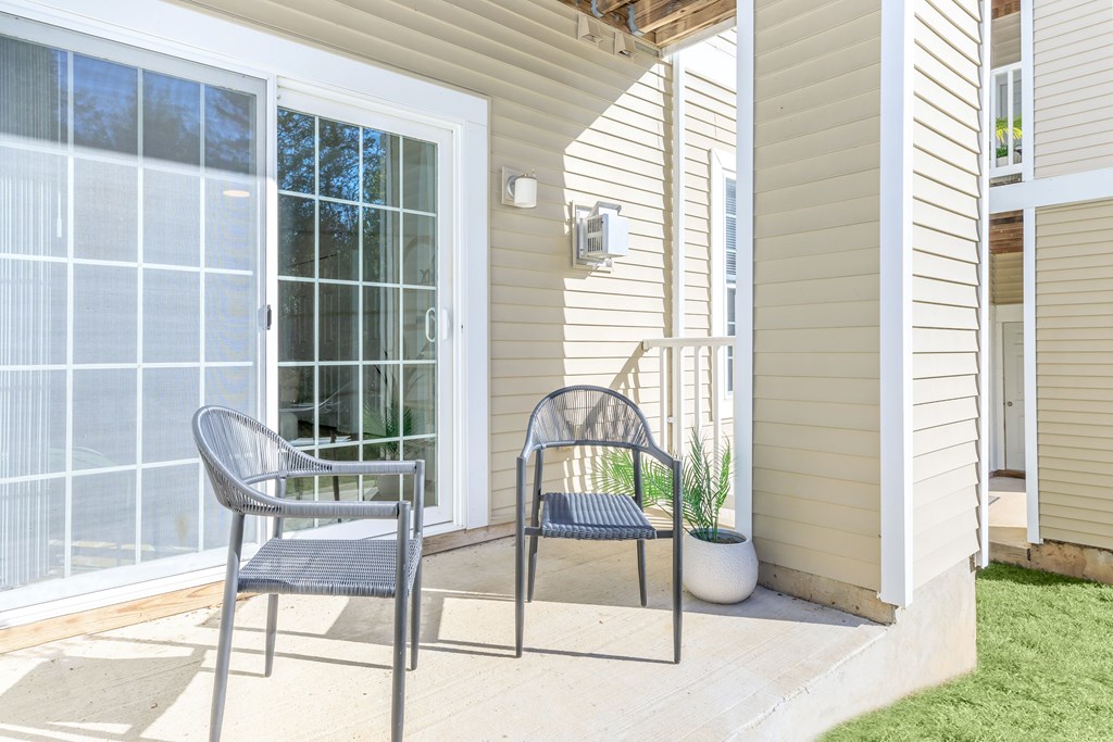 A chair and a table are placed on a patio.