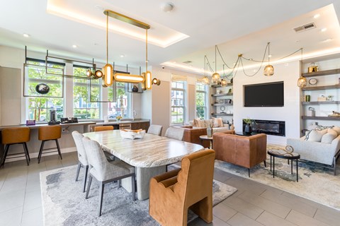 A modern dining room with a large table and chairs.