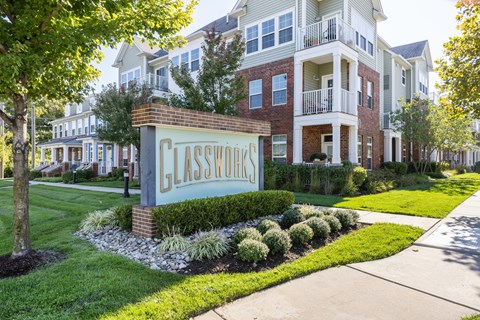 A sign that says Glasswood in front of a building.
