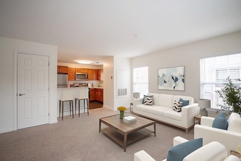 A living room with a white couch and a coffee table.