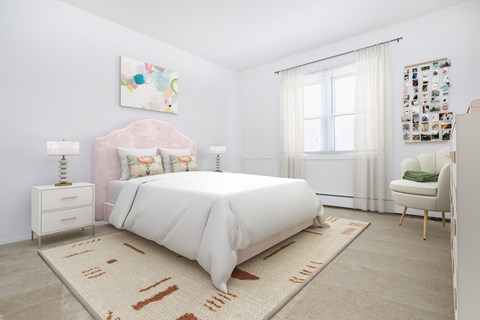 A bedroom with a large bed and a pink headboard.