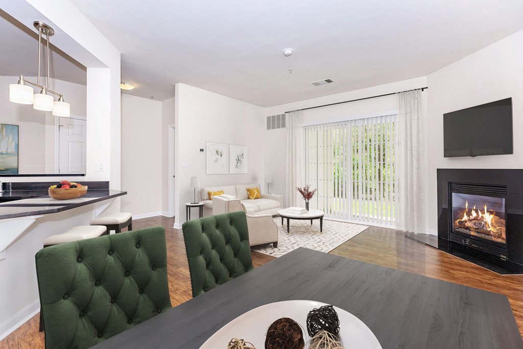 A modern living room with a fireplace and a dining table.
