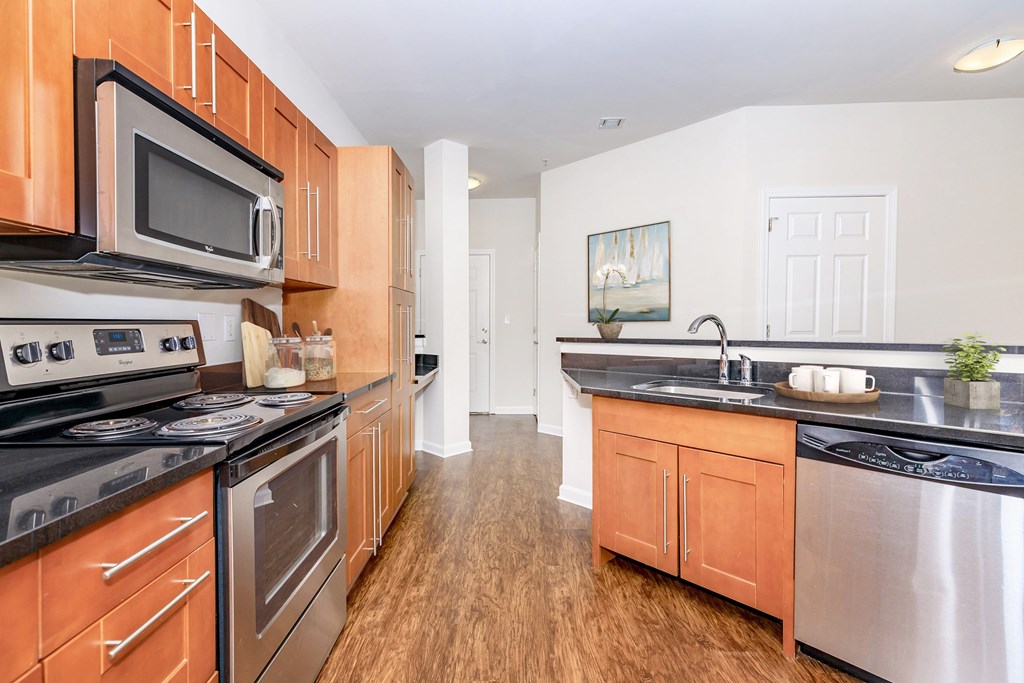 A kitchen with wooden cabinets and stainless steel appliances.