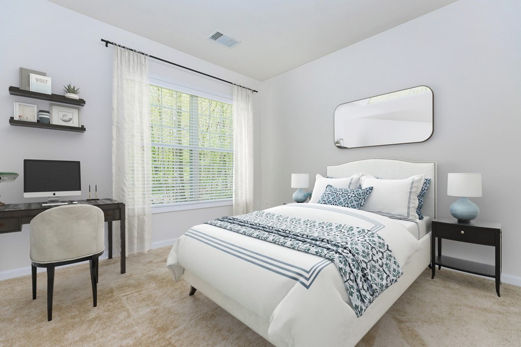 A bedroom with a bed, desk, and chair.