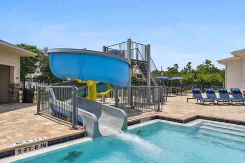 A blue water slide in a pool.
