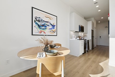 A modern dining room with a round table and chairs.