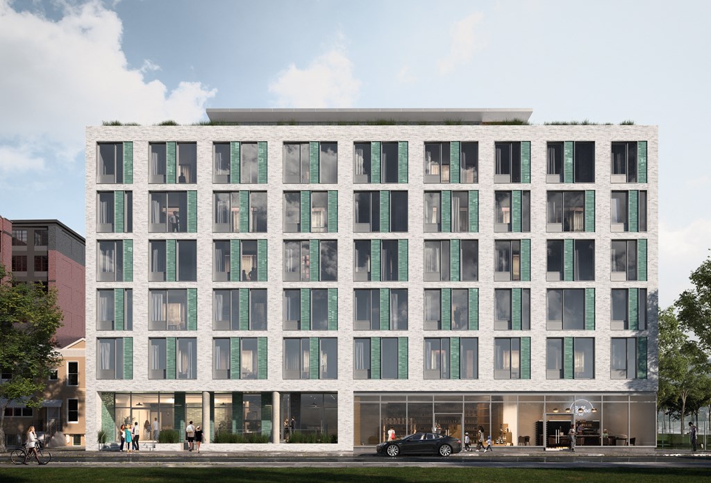 a white building with many windows and a street in front of it