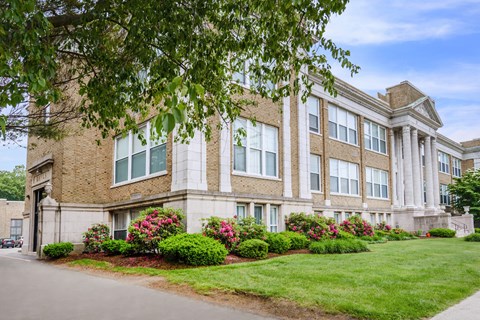 A large building with a lawn in front of it.