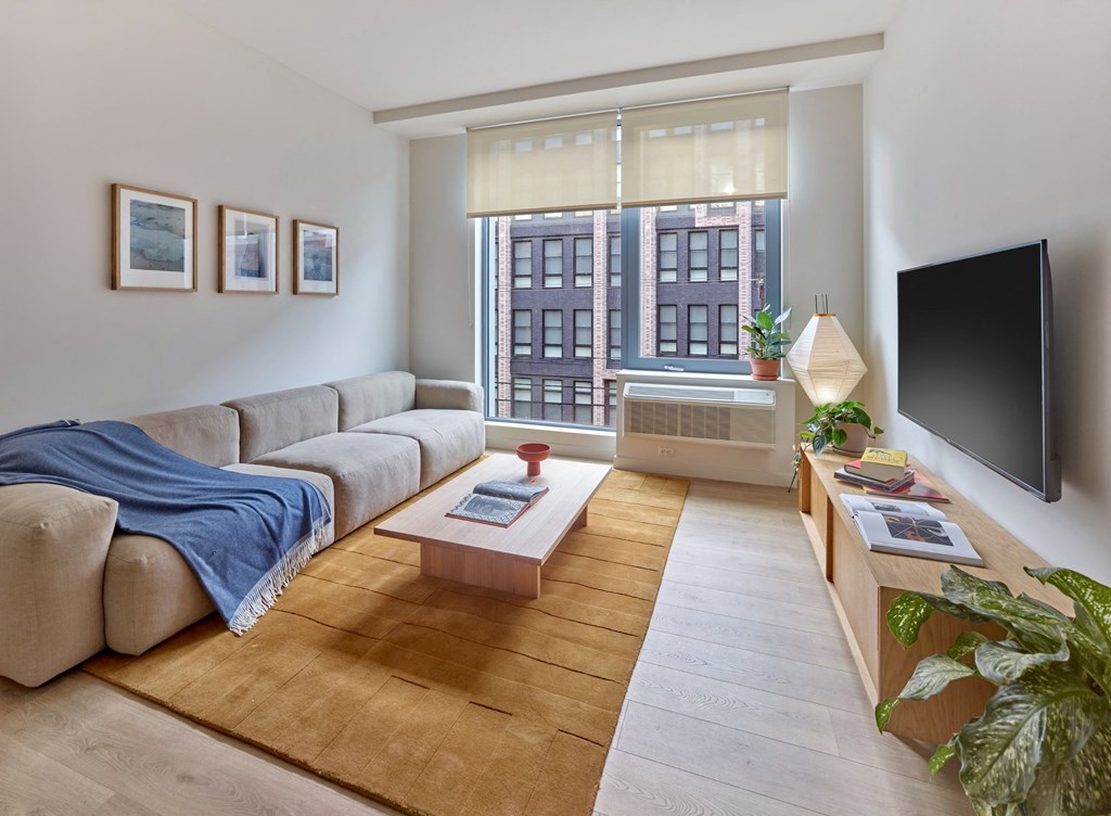 The living room at The Hazel is a cozy yet elegant space filled with natural light