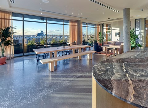 a living room with a table and a view of the city
