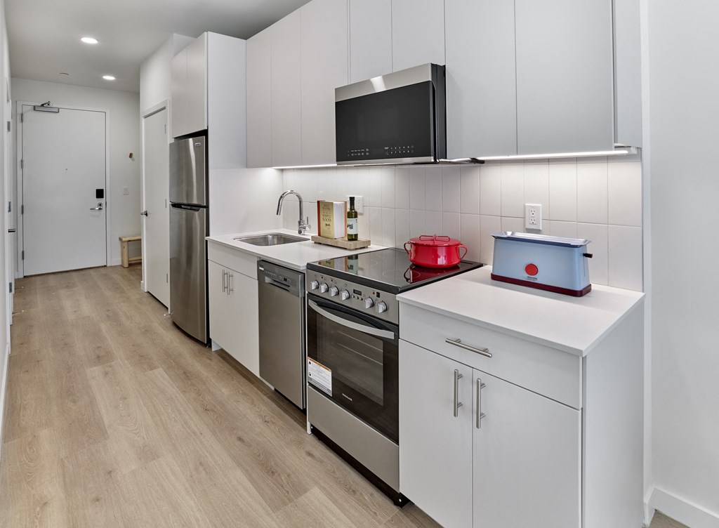 The kitchen boasts a sleek and modern design, complete with top-of-the-line electronic appliances, creating a culinary haven where you can effortlessly prepare meals with style and convenience.