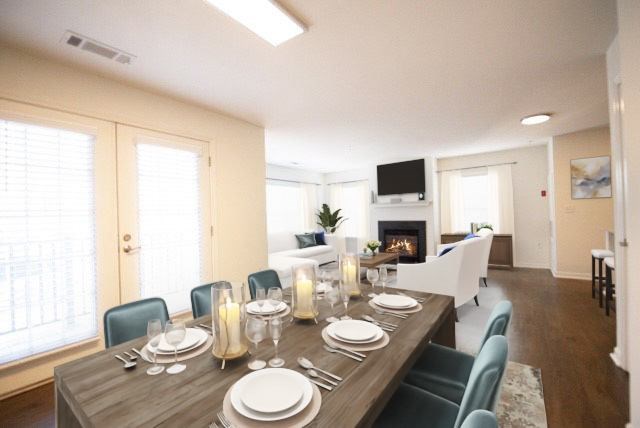 A dining room with a table set for a meal.