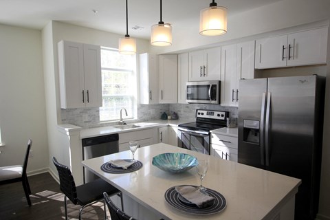 A kitchen with a table set for two.
