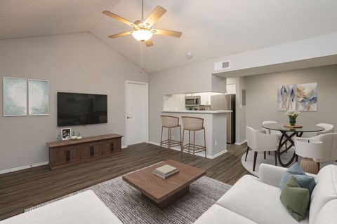 A living room with a white couch and a wooden coffee table.