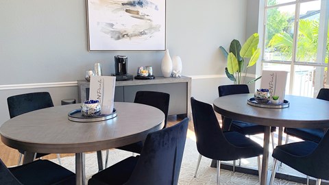 A dining room with a round table and chairs.