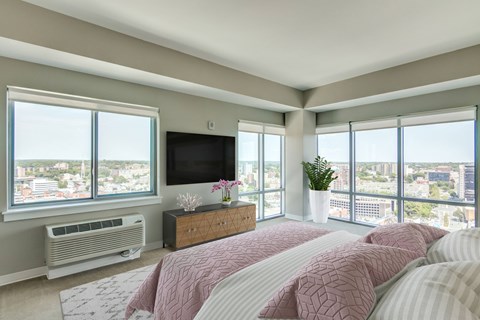 A bedroom with a large bed and a flat screen TV.