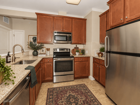 A kitchen with wooden cabinets and stainless steel appliances.