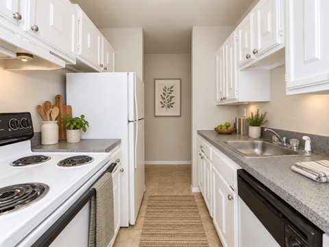 A kitchen with white cabinets and a stove top oven.