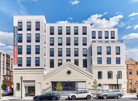 the facade of a building with cars parked in front of it