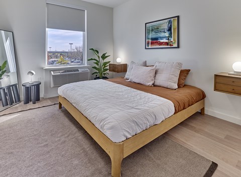 a bedroom with a large bed and a window