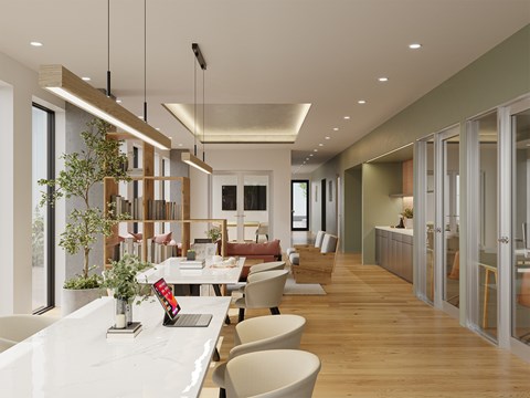 A modern dining area with a long table and chairs.